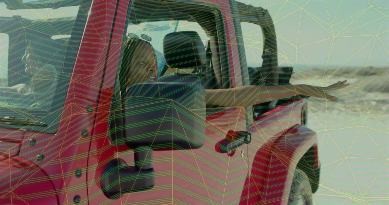 Red jeep cruising sending passenger raising arm out window fanning fingers in coastal travel breeze