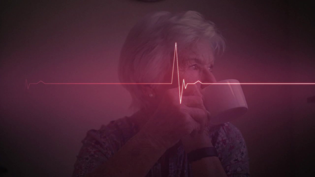 Animation of heartbeat line over thoughtful caucasian senior woman drinking coffee at home