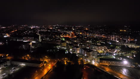 aerial tracking shot overlooking the cityscape of turku city, night in finland