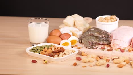 variety of protein-rich foods on wooden table