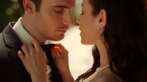 Sweet-couple-standing-in-park.-Man-and-woman-getting-ready-for-wedding-outdoors