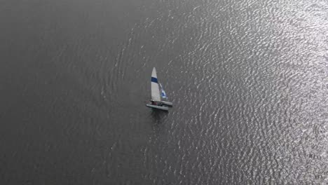 sailboat in the middle of a lake or ocean, 4k drone footage