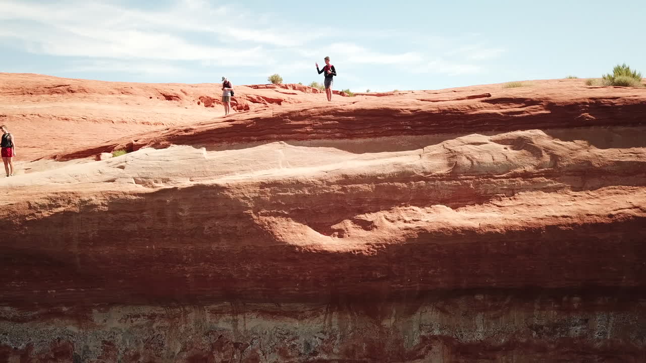 Drone shot of cliff jumper doing trick in Lake Powell Utah