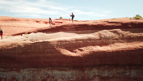 drone shot of cliff jumper doing trick in lake powell utah