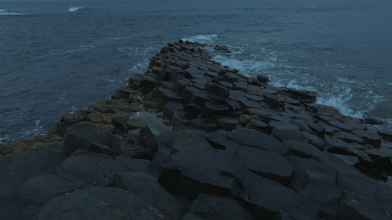 Slow motion shot of ripples splashing on Gian's Causeway basalt hexagonal columns