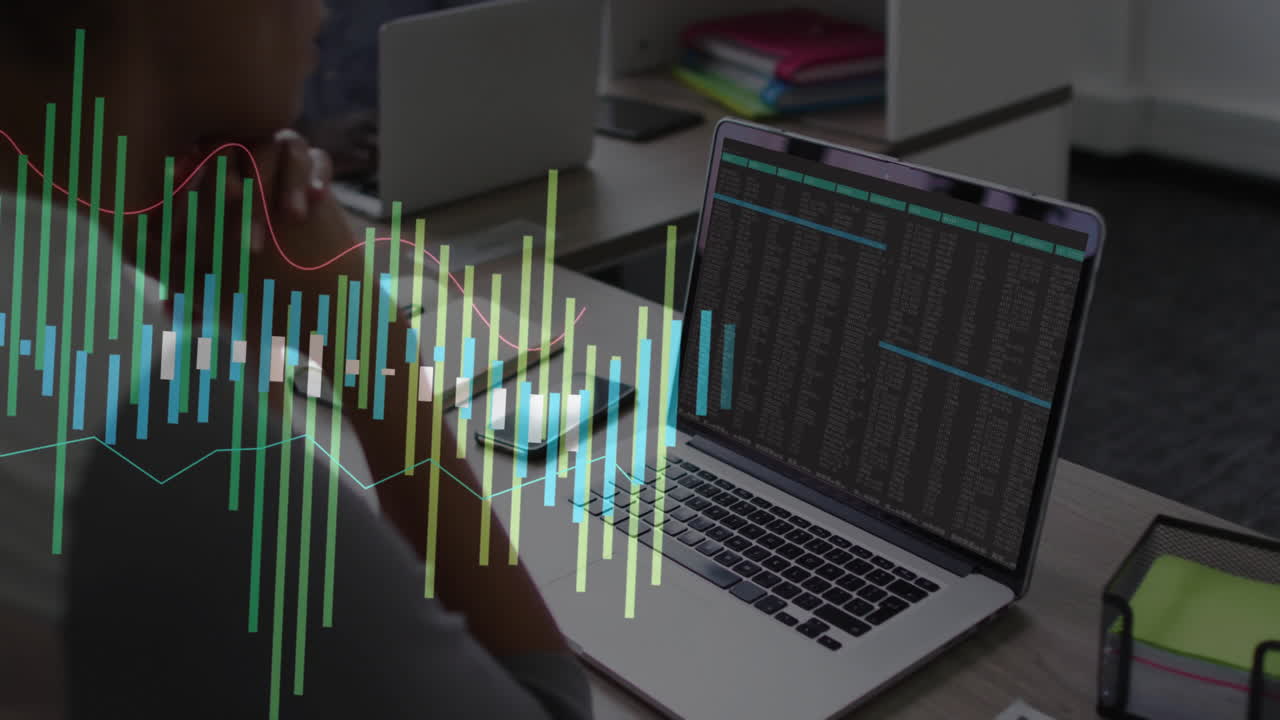 Stock market data animation over person working on laptop in office