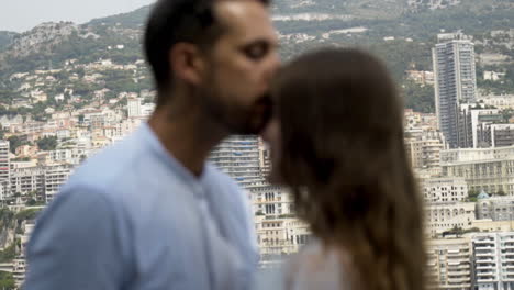 couple kissing with monaco skyline