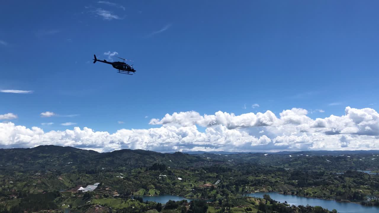 Helicopter flying around the rock of guatape. Helicopter ride through the Embalse peñol - guatape.
