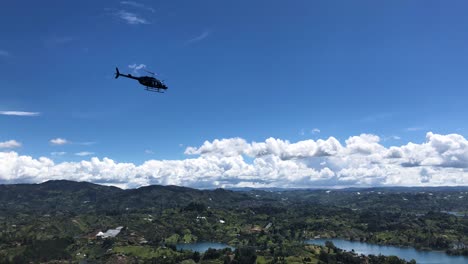 helicopter flying around the rock of guatape. helicopter ride through the embalse peñol - guatape.