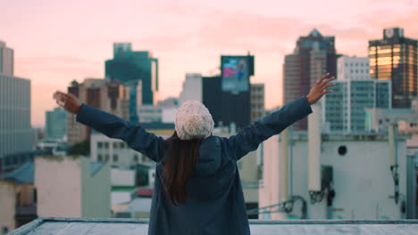 sunset, freedom and a woman on city rooftop