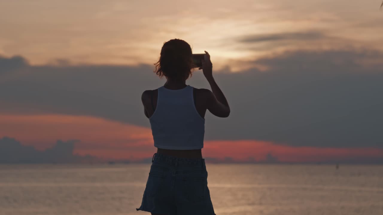 Woman Taking Photo of Sunrise at Beach