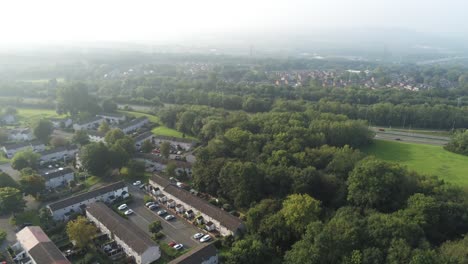 urban aerial view looking down over park suburbs homes townscape panning right