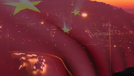 animation of waving chinese flag against aerial view of night city traffic