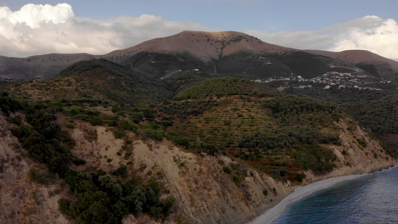 Beautiful seaside with mountain villages above blue turquoise sea water near Saranda, Albania