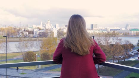 woman on balcony with city view