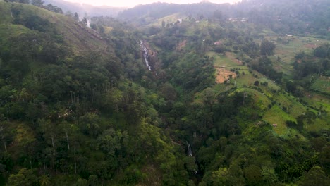 two waterfalls surrounded of tea plantations in ella, sri lanka