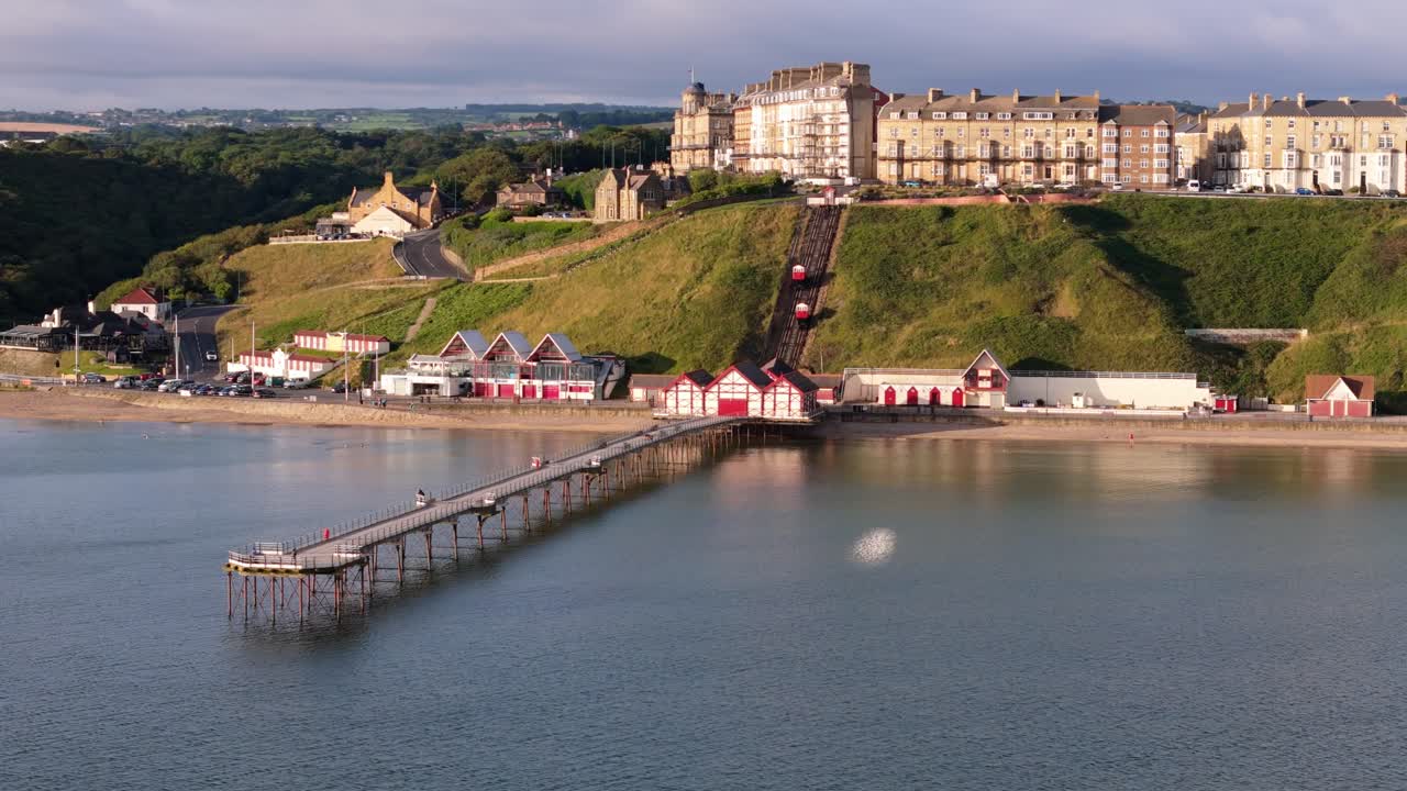 Aerial drone view of Saltburn-by-the-sea, Saltburn pier and ocean in Cleveland, North Yorkshire in summer, early morning