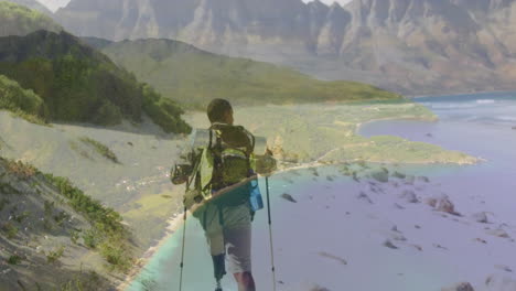 composite video of a beach against african american man hiking on the mountains