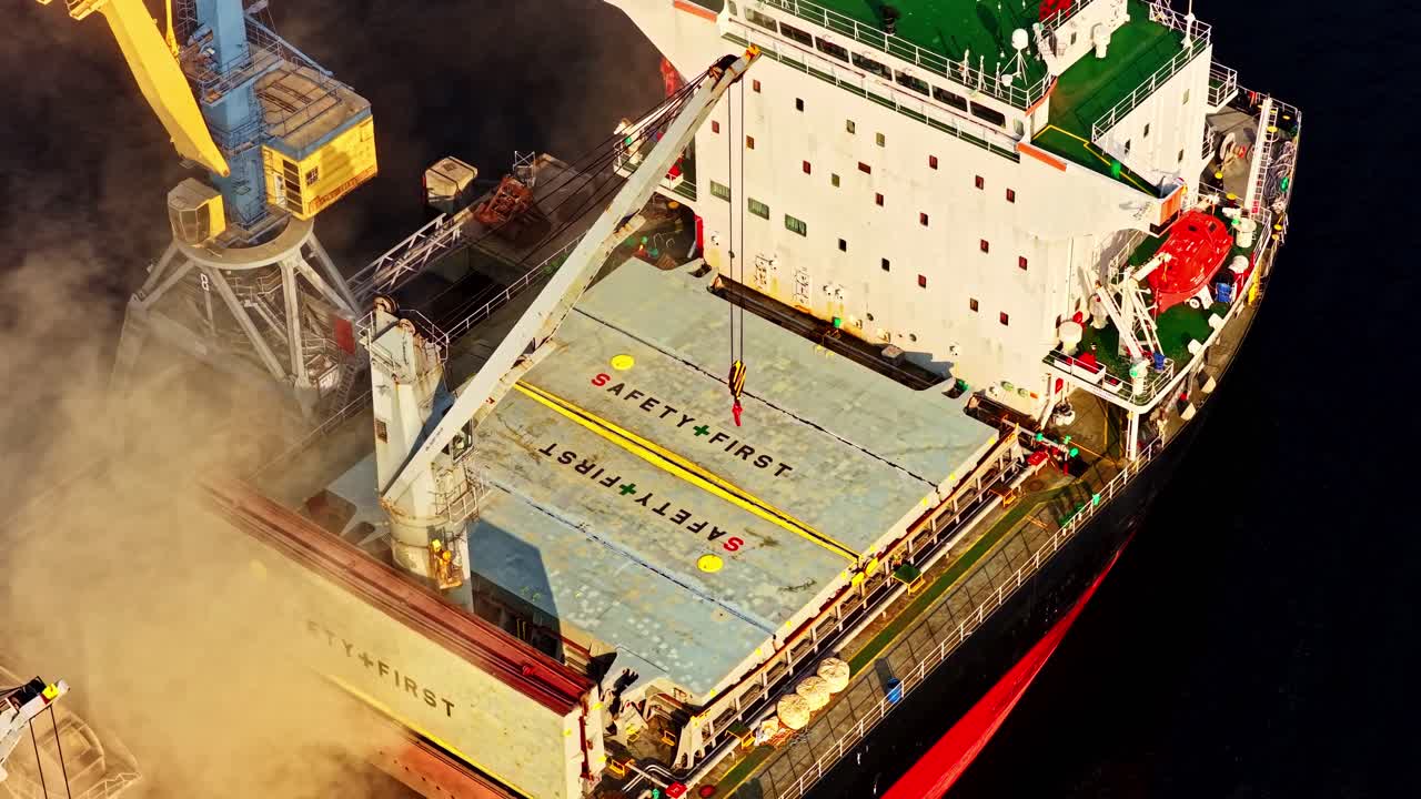 Top Down Perspective of a large ship being loaded with grain by a conveyor belt