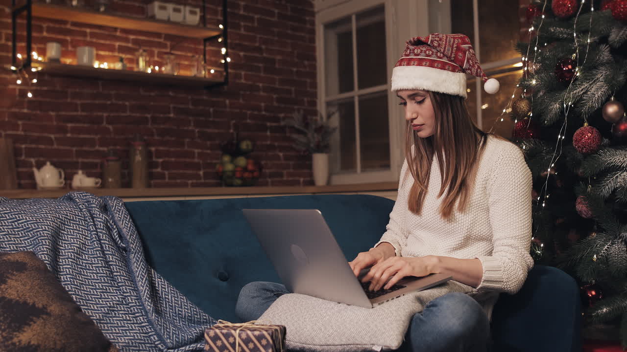 Woman receives a Christmas gift while on a video call