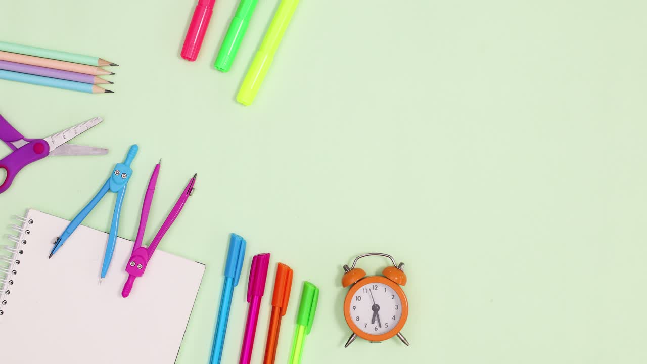 School writing stationery ordering on light green background. Stop motion