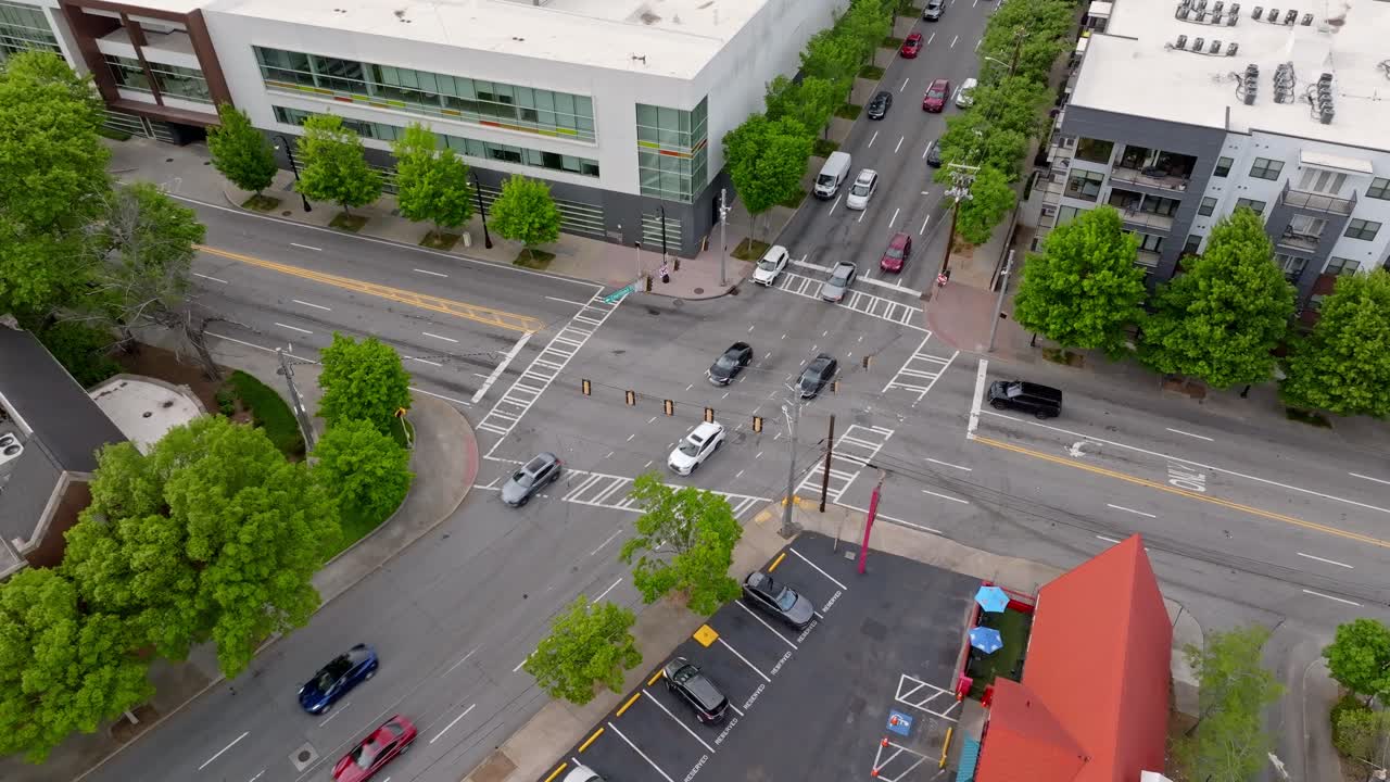 Green traffic signal intersection through financial district, green trees lined suburban city road, Peachtree center, Atlanta, Georgia, Aerial view