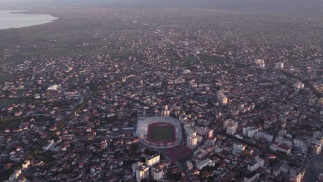 tilt down shot of the city shkoder in albania during sunrise in autumn, aerial