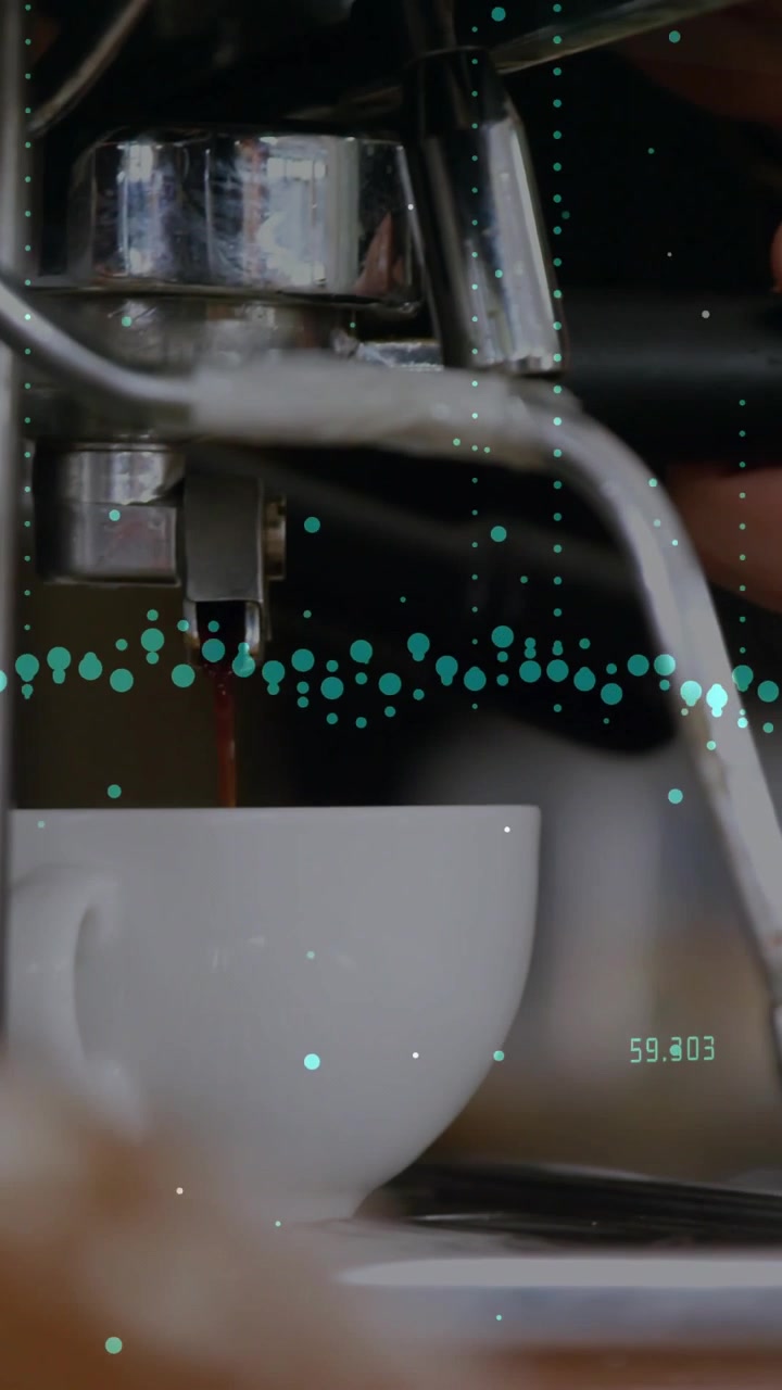 Vertical video: Barista engaging handle and brewing espresso while turquoise data overlay animating