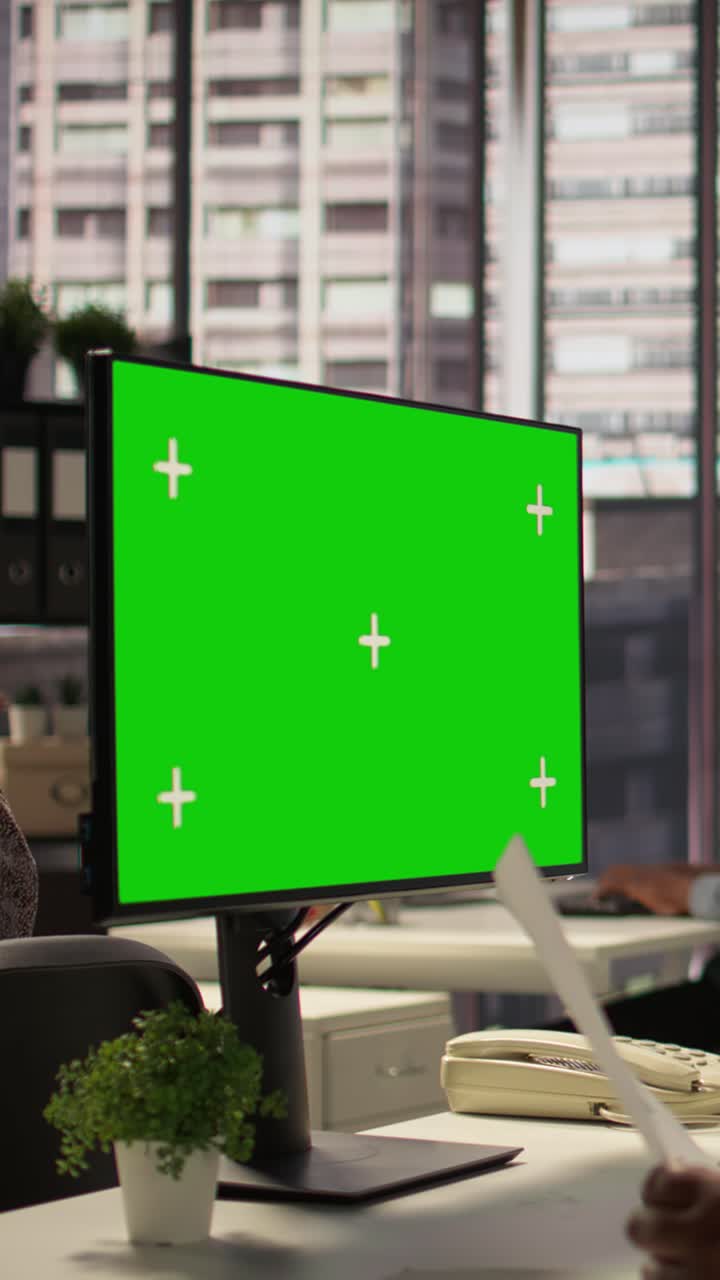 Green Screen Computer Monitor on Office Desk with People Working