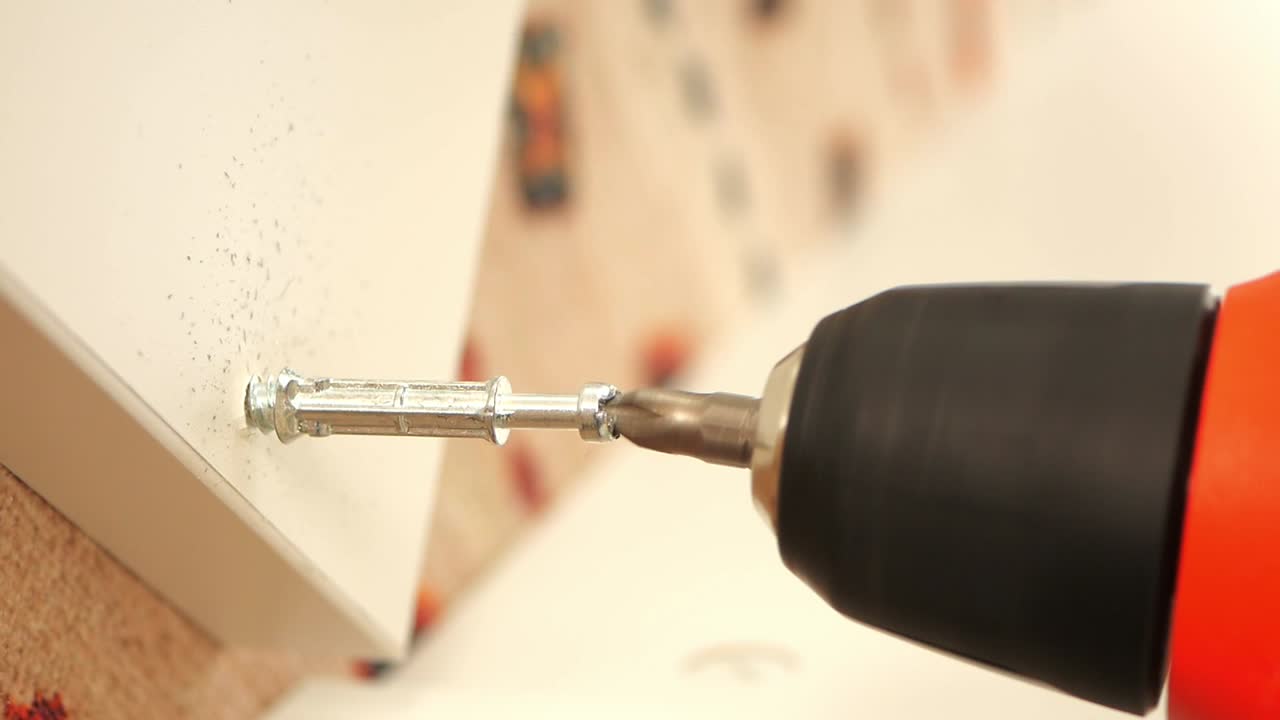 Drilling a screw into a wall