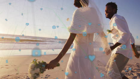 walking on beach, bride and groom with social media icons animation over scene