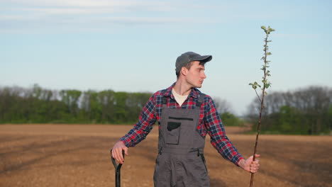 farmer planting an apple tree