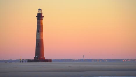 The-Morris-Island-lighthouse-at-sunrise,-follybeach