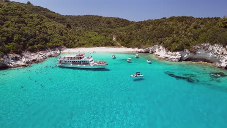 flyover ships in crystal clear water to tourists swimming in bay