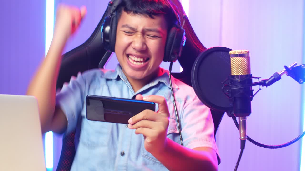 Asian Kid Boy Playing Video Game With Mobile Phone Then Celebrating While Live Stream