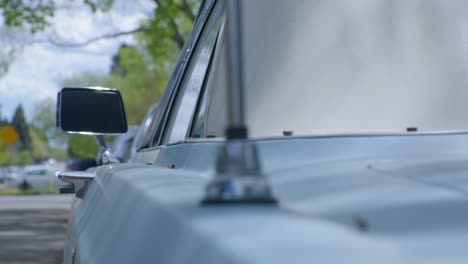 vintage car blue mercury side view mirror and antena