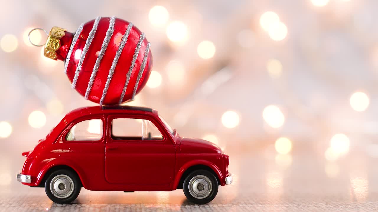 Christmas red car with Christmas ornament on the roof and blinking lights