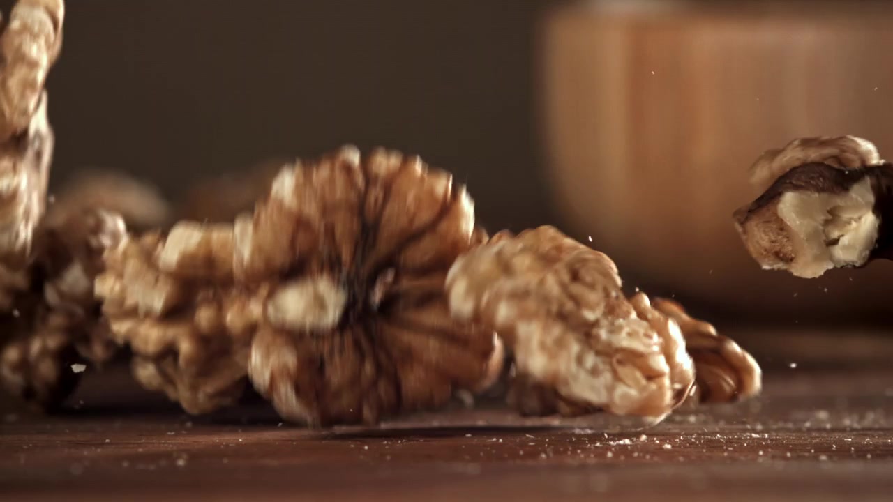 Walnuts Falling in Slow Motion on a Wooden Table