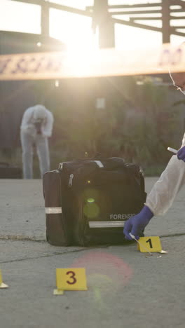 a forensic investigator collecting evidence at a crime scene