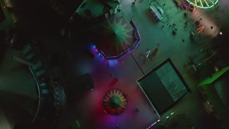 Drone-of-a-completely-empty-fairground-with-colorful-lights-on