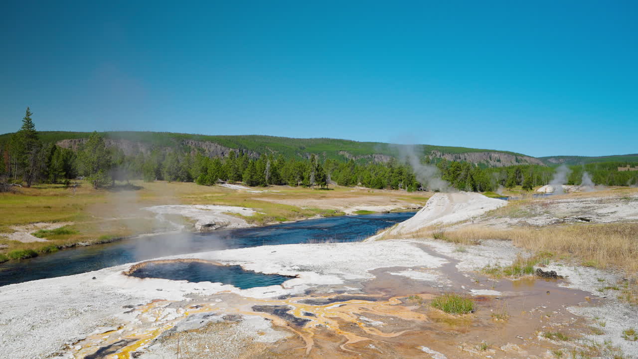 Scenic view of hot springs and a river in Yellowstone National Park