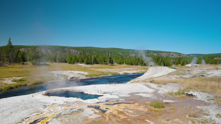 Scenic view of hot springs and a river in Yellowstone National Park