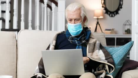 portrait of sick man wearing a surgical mask and sitting in the living room