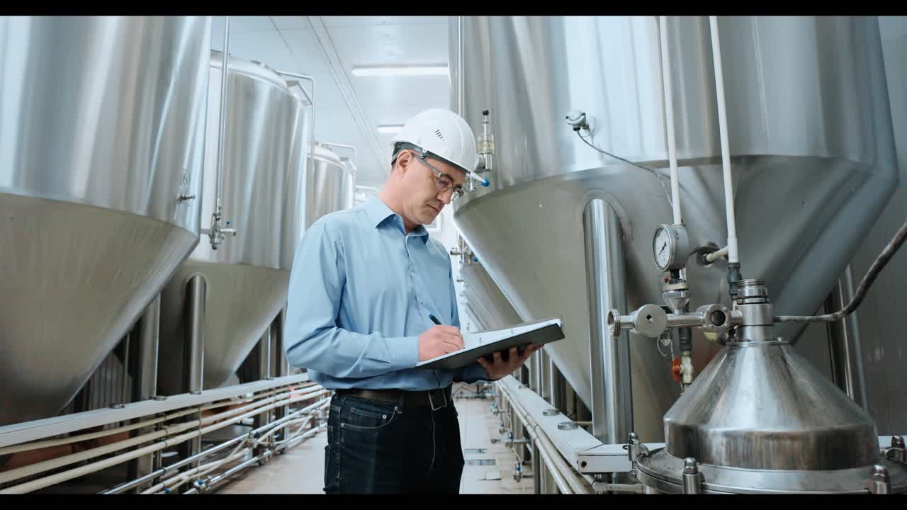 Brewery Engineer Inspecting Equipment
