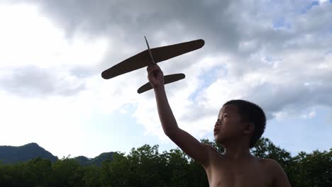 a child plays with a paper airplane