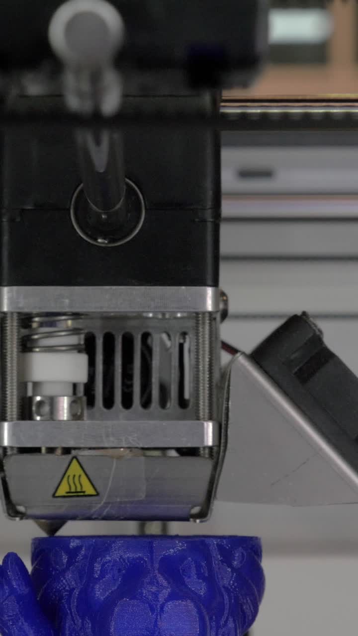 Close-Up of a 3D Printer Extruding Blue Plastic Filament