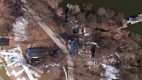 Rural-housing-area-by-green-lake-during-winter