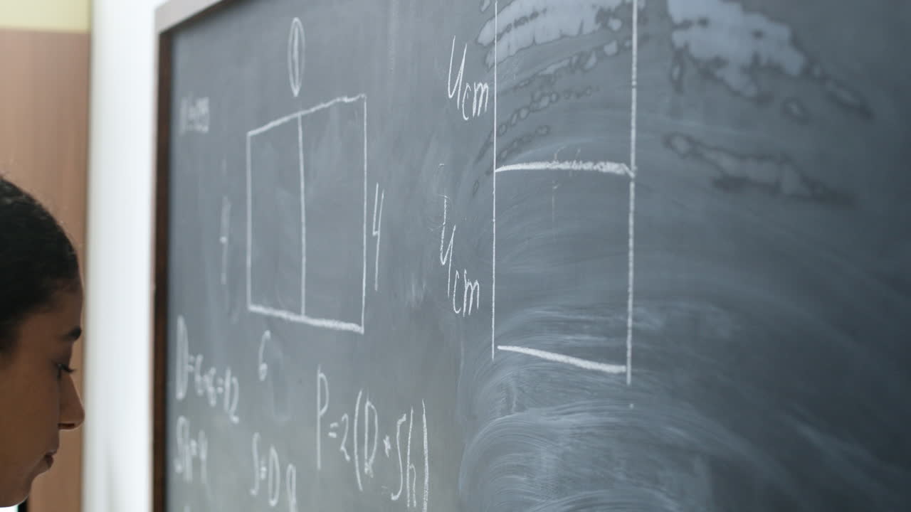 Student Solving Geometry Problem on Chalkboard