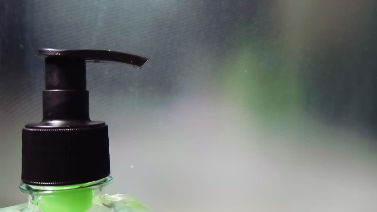 Man's hands take soap from an soap dispenser with a blurred background. Close up. Corona Virus idea