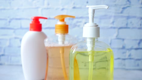 three different colored soap dispensers